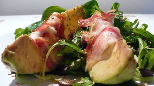 Закуска из авокадо, фаршированного мягким козьим сыром, с прошутто на подушке из полевого салата